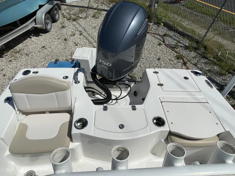 Slide: The Image of 2017 Robalo 206 Cayman boat interior with Yamaha 150 engine, seating, and storage compartments. - 11