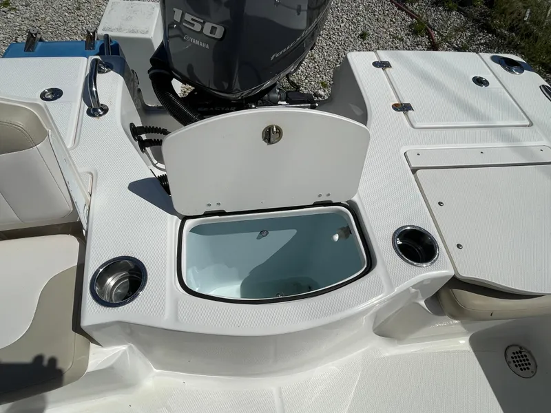 Slide: The Image of 2017 Robalo 206 Cayman boat deck with open storage compartment and Yamaha 150 engine. - 12