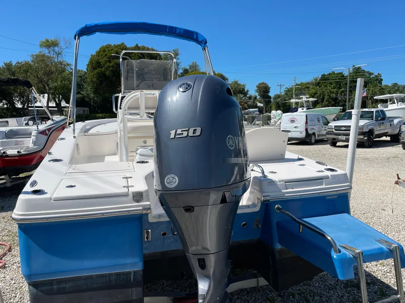 Slide: The Image of 2017 Robalo 206 Cayman boat with Yamaha 150 engine, blue hull, parked outdoors. - 14