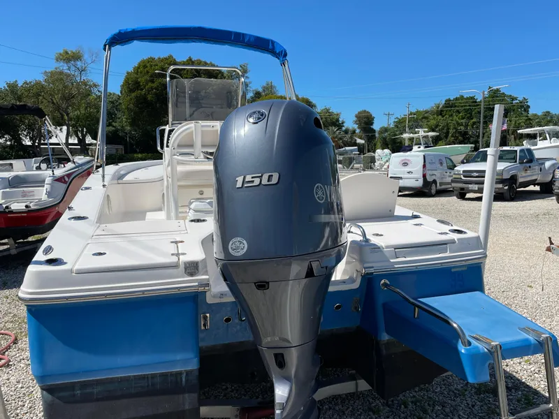 Slide: The Image of 2017 Robalo 206 Cayman boat with Yamaha 150 engine, blue hull, parked outdoors. - 15