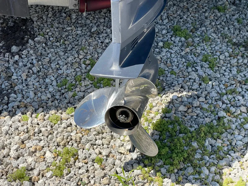 Slide: The Image of Propeller of 2017 Robalo 206 Cayman boat on gravel surface. - 16
