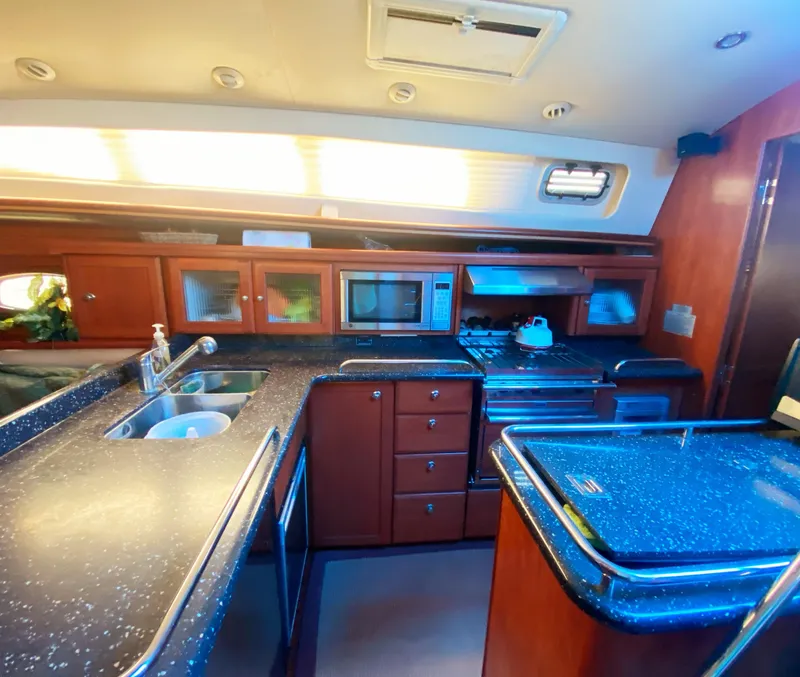 Slide: The Image of Luxurious 2012 Hunter 50 Aft Cockpit yacht kitchen with modern appliances and sleek countertops. - 10