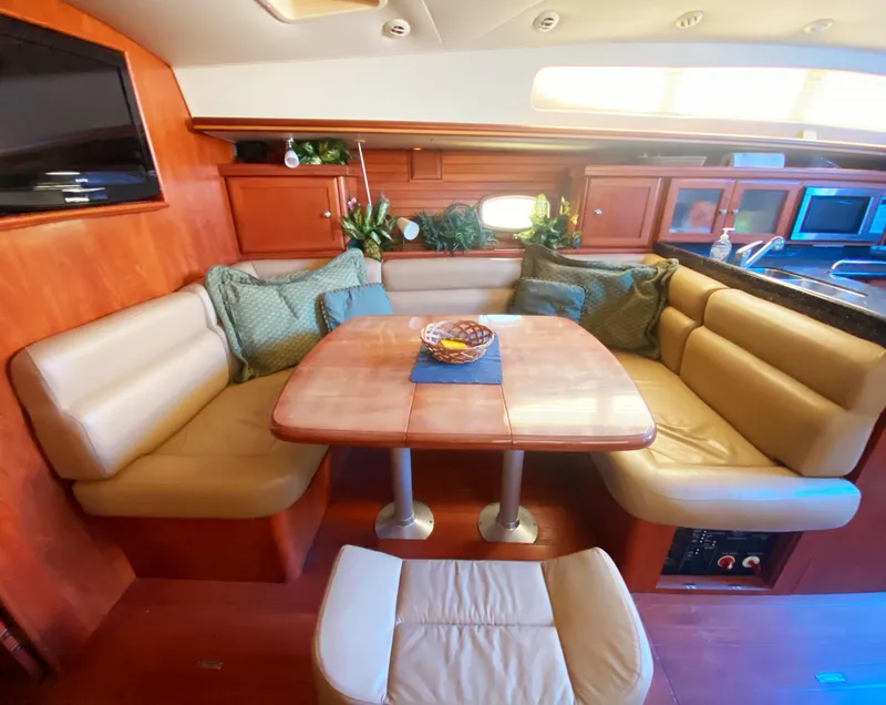 Slide: The Image of Luxurious 2012 Hunter 50 Aft Cockpit interior with cozy seating and elegant dining area. - 15