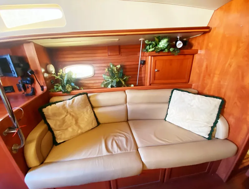 Slide: The Image of Luxurious interior of 2012 Hunter 50 Aft Cockpit yacht with beige sofa and wooden cabinetry. - 16