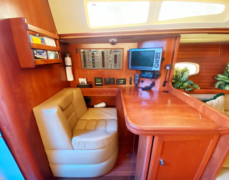 Slide: The Image of Luxurious 2012 Hunter 50 Aft Cockpit interior with navigation station and plush seating. - 17