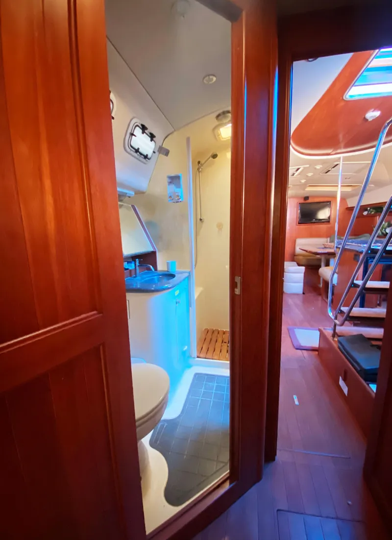 Slide: The Image of Interior of 2012 Hunter 50 Aft Cockpit yacht, featuring bathroom and living area. - 23