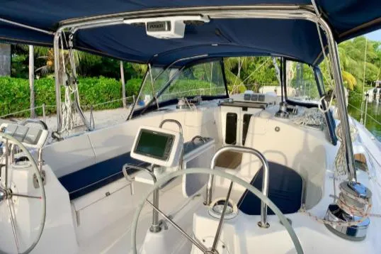 Slide: The Image of 2012 Hunter 50 Aft Cockpit sailboat with modern navigation equipment and blue canopy. - 3
