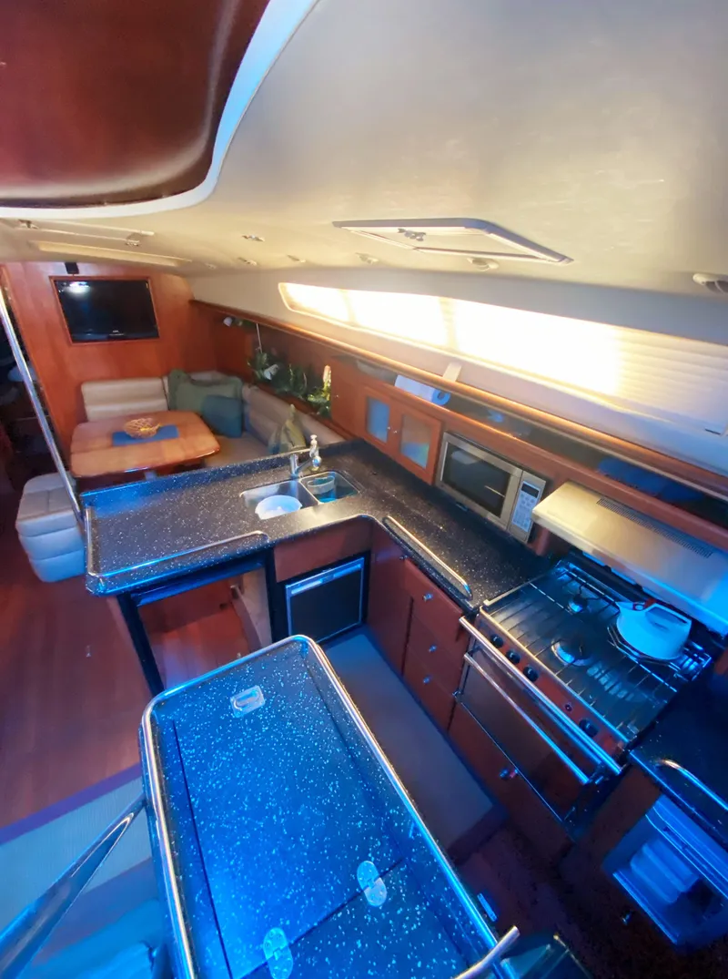 Slide: The Image of Luxurious interior of 2012 Hunter 50 Aft Cockpit yacht with modern kitchen and seating area. - 6