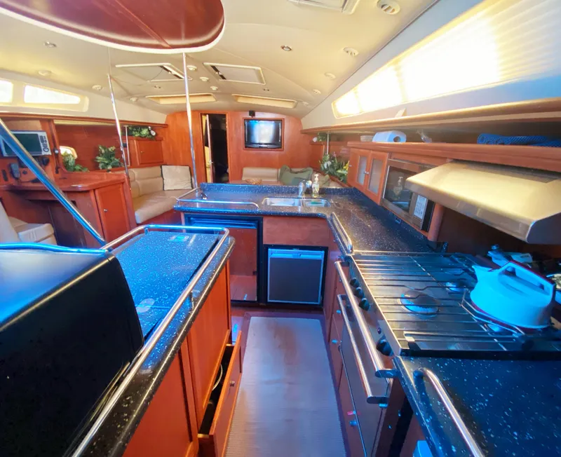 Slide: The Image of Luxurious interior of 2012 Hunter 50 Aft Cockpit yacht with modern kitchen amenities. - 7