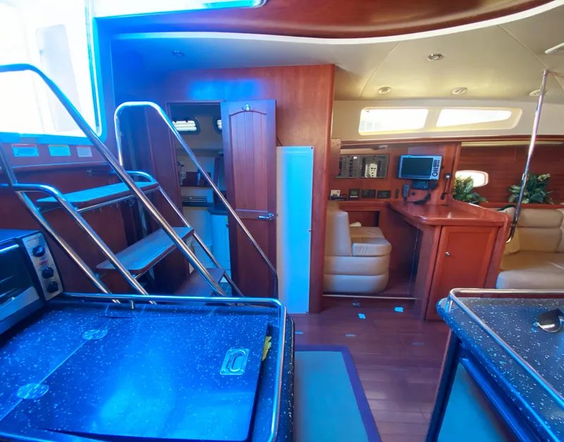 Slide: The Image of Interior of 2012 Hunter 50 Aft Cockpit yacht with modern amenities and wooden finishes. - 9