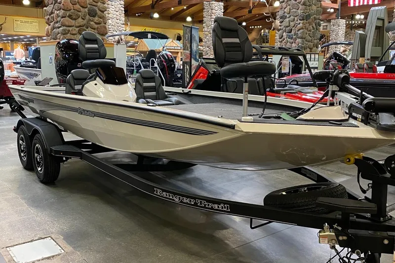Slide: The Image of 2025 Ranger RT198P fishing boat on display indoors, featuring dual seats and a sleek design. - 0