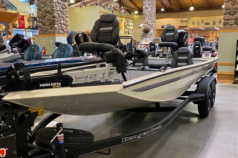 Slide: The Image of 2025 Ranger RT198P fishing boat with Minn Kota motor on display indoors. - 1