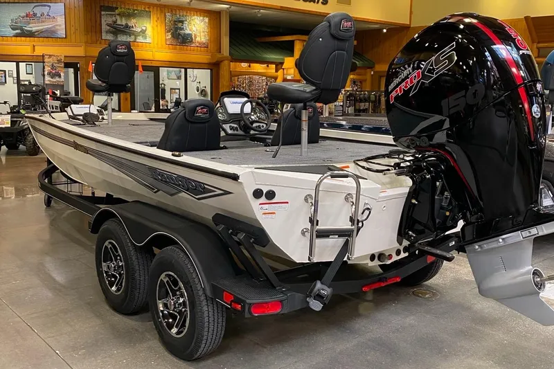 Slide: The Image of 2025 Ranger RT198P fishing boat with powerful outboard motor in showroom. - 2