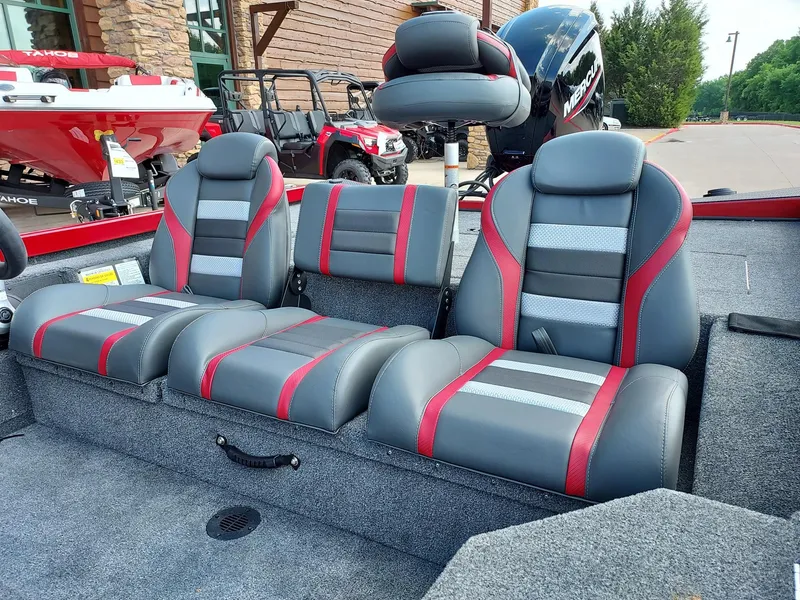 Slide: The Image of 2025 Ranger RT178 boat interior with gray and red seating, outdoor display. - 1