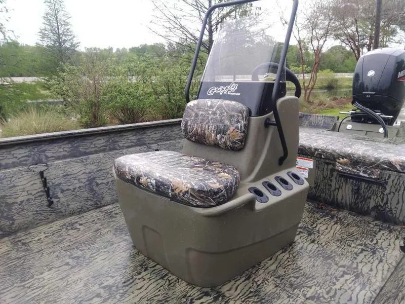 Slide: The Image of 2025 Tracker Grizzly 2072 CC boat with camo seating and console, ideal for outdoor adventures. - 10