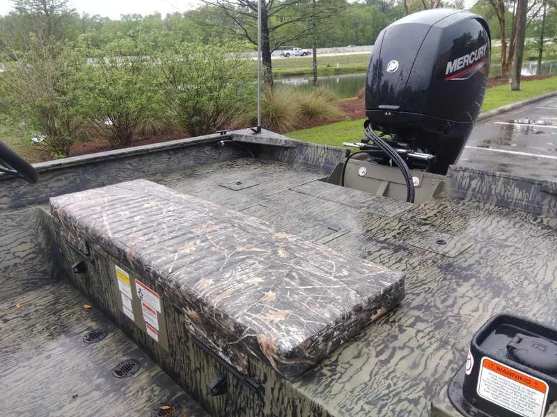 Slide: The Image of 2025 Tracker Grizzly 2072 CC boat with camo design and Mercury outboard motor. - 12