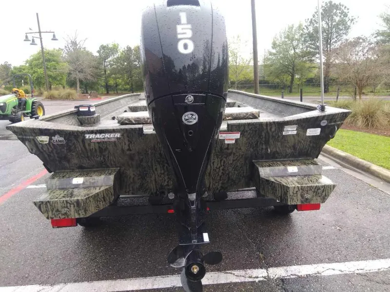 Slide: The Image of 2025 Tracker Grizzly 2072 CC boat with 150 HP motor, parked outdoors. - 3