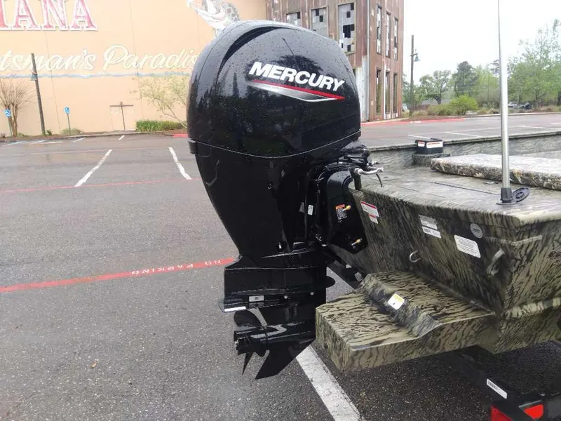 Slide: The Image of 2025 Tracker Grizzly 2072 CC with Mercury outboard motor in a parking lot. - 4