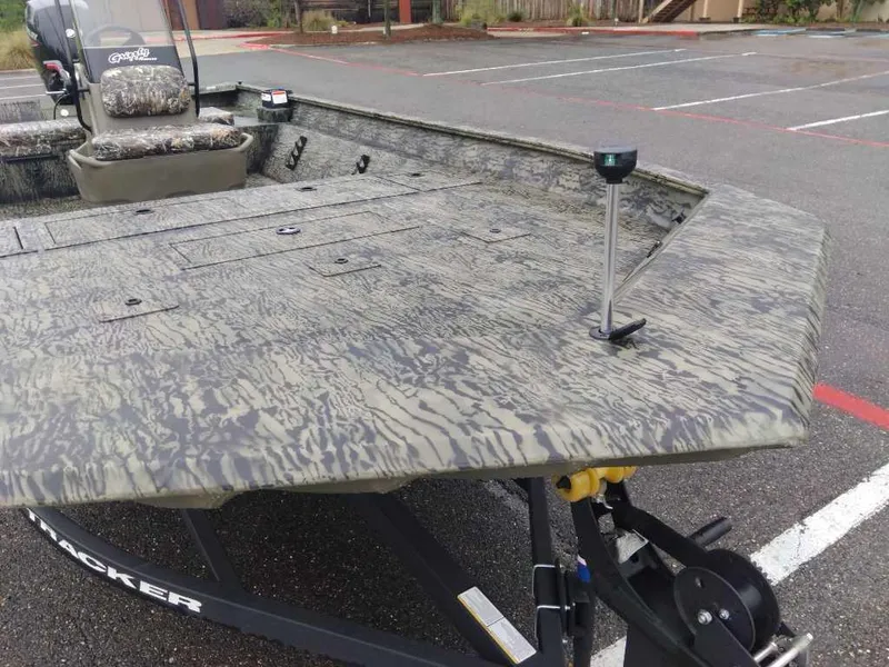 Slide: The Image of 2025 Tracker Grizzly 2072 CC boat with camouflage design in a parking lot. - 8