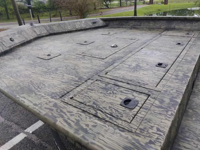 Slide: The Image of 2025 Tracker Grizzly 2072 CC boat deck with storage compartments, featuring a camouflage pattern. - 9