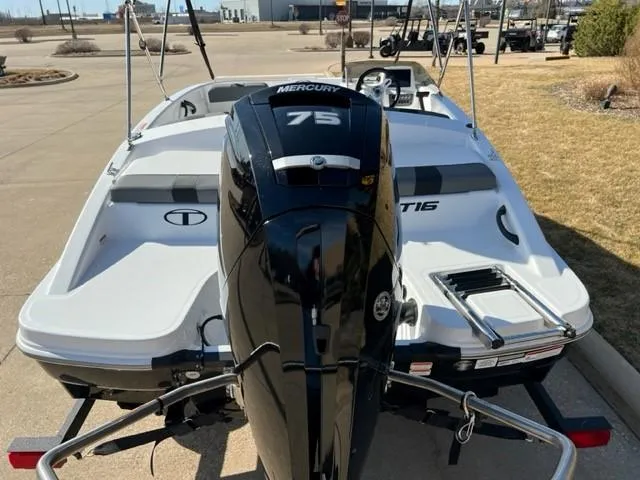 Slide: The Image of 2025 Tahoe T16 boat with Mercury 75 engine, parked outdoors. - 4