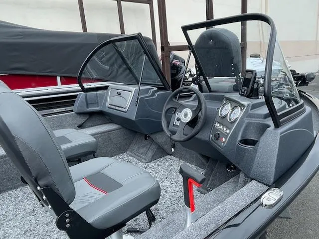 Slide: The Image of 2025 Tracker Pro Guide V-16 WT boat interior with steering wheel and seating. - 2