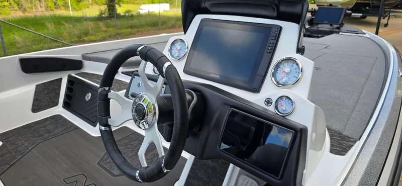 Slide: The Image of 2025 Nitro Z21 XL Pro boat dashboard with steering wheel and digital displays. - 4