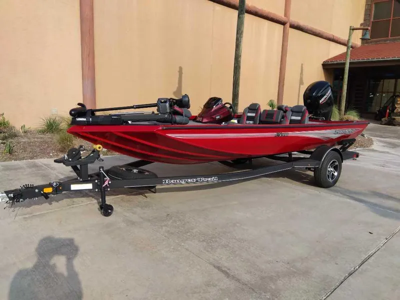The Image of 2025 Ranger RT178 boat in red, parked on a trailer outside a building. - 0