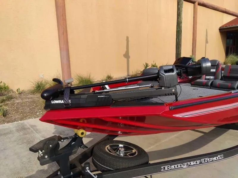 Slide: The Image of 2025 Ranger RT178 boat on trailer, featuring a red hull and Lowrance equipment. - 3