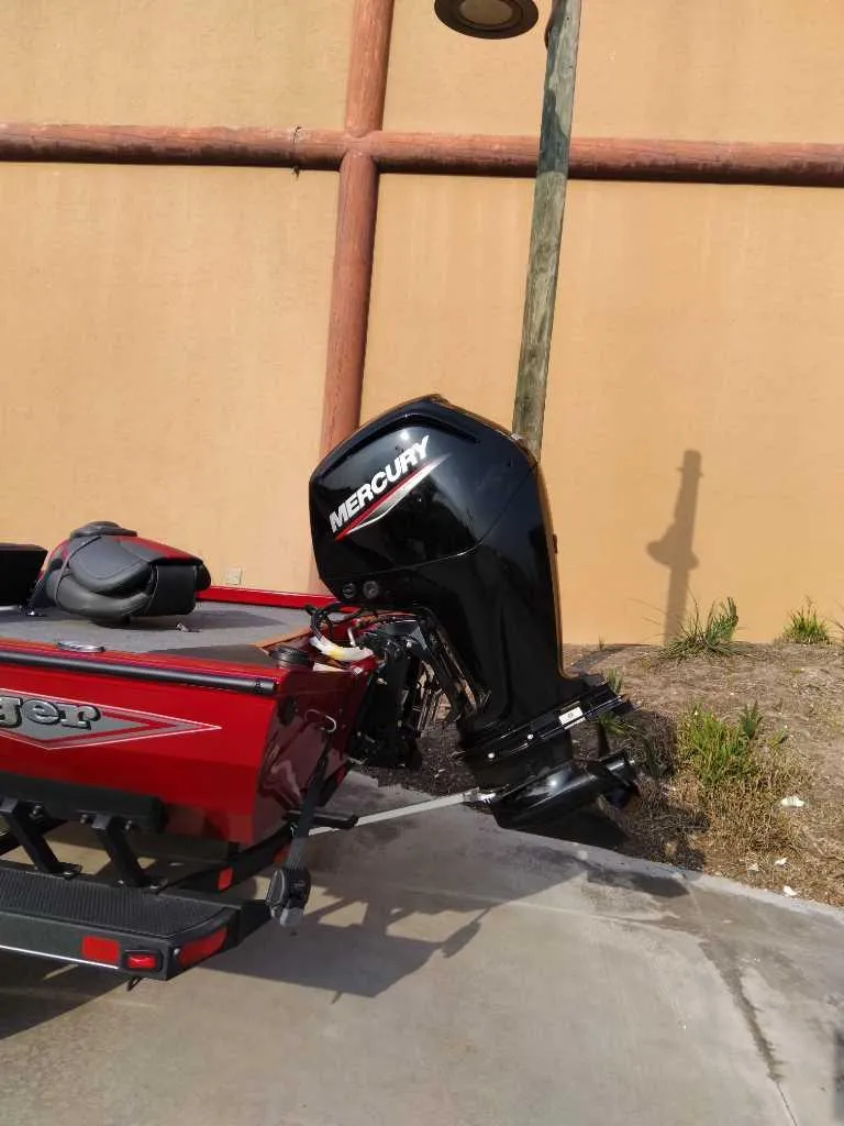 Slide: The Image of 2025 Ranger RT178 boat with Mercury outboard motor, parked outdoors. - 6