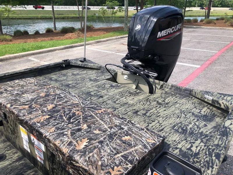 Slide: The Image of 2025 Tracker Grizzly 1860 CC boat with camouflage design and Mercury outboard motor. - 12