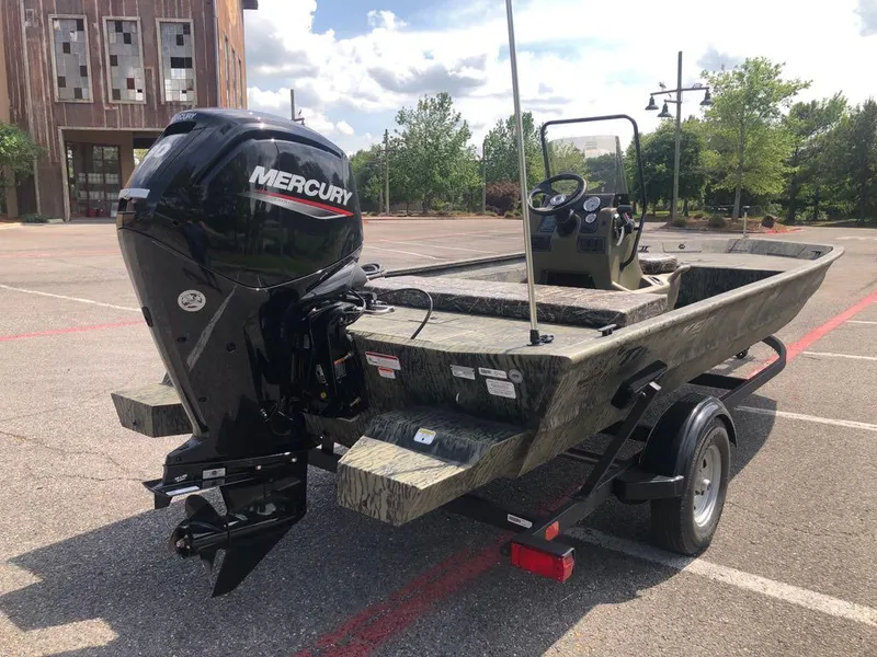 Slide: The Image of 2025 Tracker Grizzly 1860 CC boat with Mercury engine in parking lot. - 4