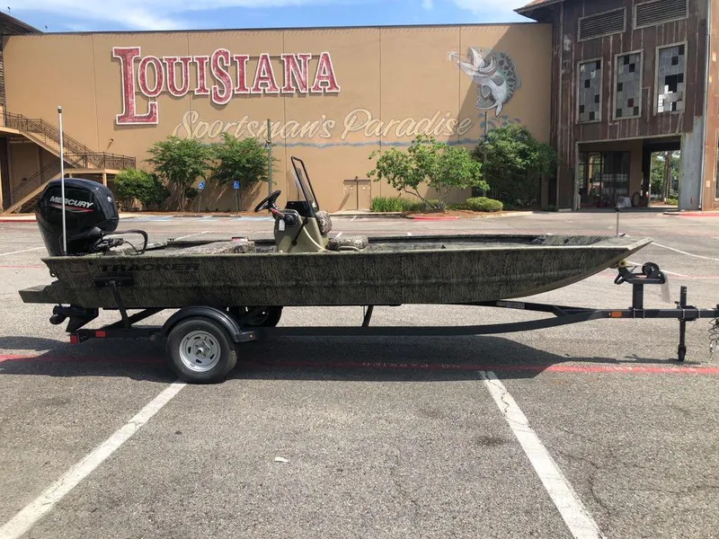 Slide: The Image of 2025 Tracker Grizzly 1860 CC boat on trailer, parked in front of Louisiana Sportsman's Paradise. - 5