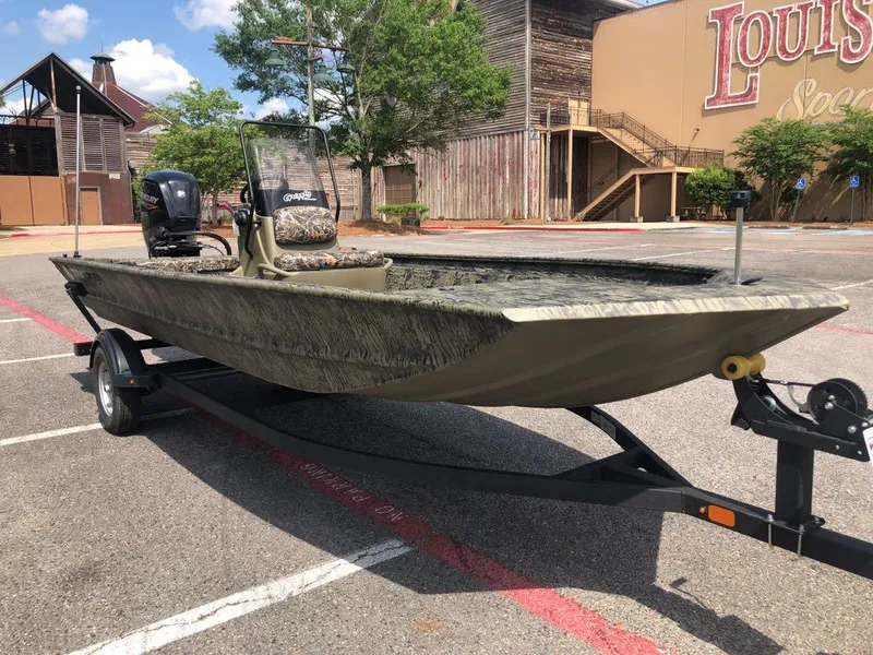 Slide: The Image of 2025 Tracker Grizzly 1860 CC boat on trailer in parking lot, sunny day. - 6
