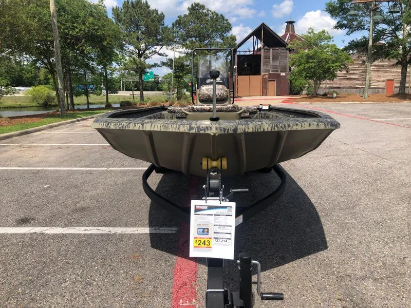 Slide: The Image of 2025 Tracker Grizzly 1860 CC boat on trailer in parking lot, sunny day. - 7