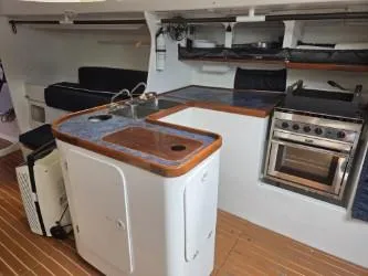 Slide: The Image of Interior of 2005 Dencho Marine Kernan 68 yacht with kitchen and seating area. - 21