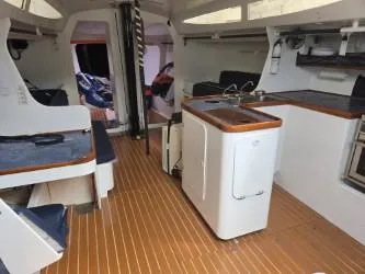 Slide: The Image of Interior of 2005 Dencho Marine Kernan 68 yacht with modern kitchen and seating area. - 23