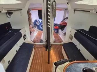 Slide: The Image of Interior of 2005 Dencho Marine Kernan 68 sailboat with wooden flooring and seating. - 24