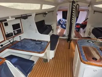 Slide: The Image of Interior of 2005 Dencho Marine Kernan 68 yacht with modern amenities and wooden flooring. - 26