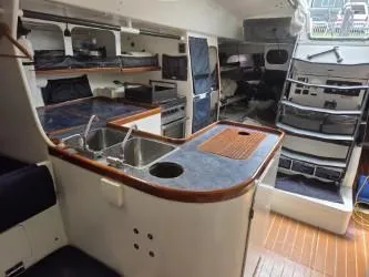 Slide: The Image of Interior of 2005 Dencho Marine Kernan 68 yacht with kitchen and seating area. - 27
