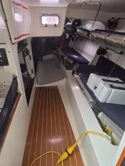 Slide: The Image of Interior of 2005 Dencho Marine Kernan 68 sailboat with wooden flooring and seating. - 28