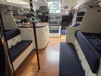 Slide: The Image of Interior of 2005 Dencho Marine Kernan 68 yacht with wooden flooring and seating. - 30