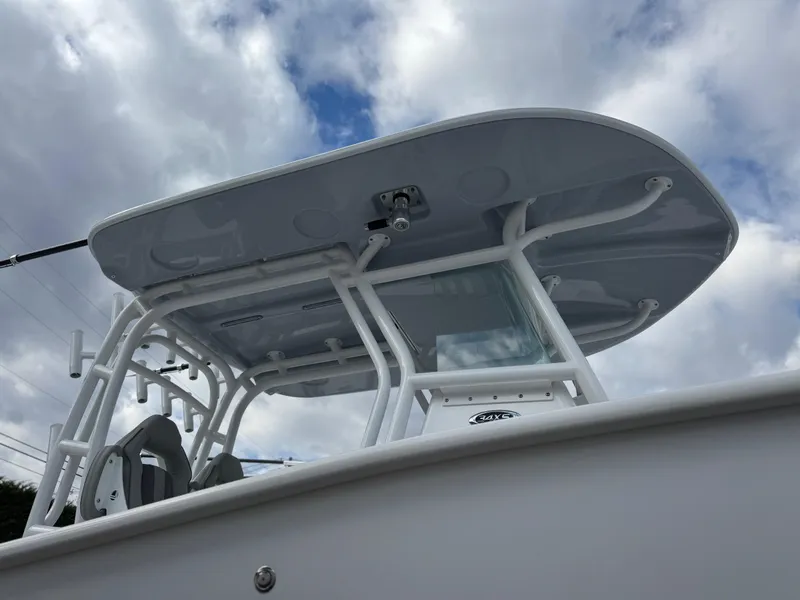 Slide: The Image of 2025 Cape Horn 34 XS boat with T-top against cloudy sky. - 2