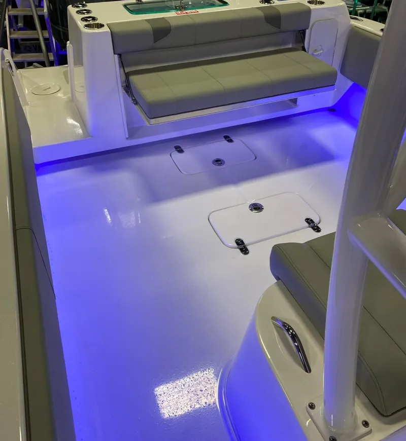 Slide: The Image of 2025 Cape Horn 34 XS boat interior with blue LED lighting and cushioned seating. - 21
