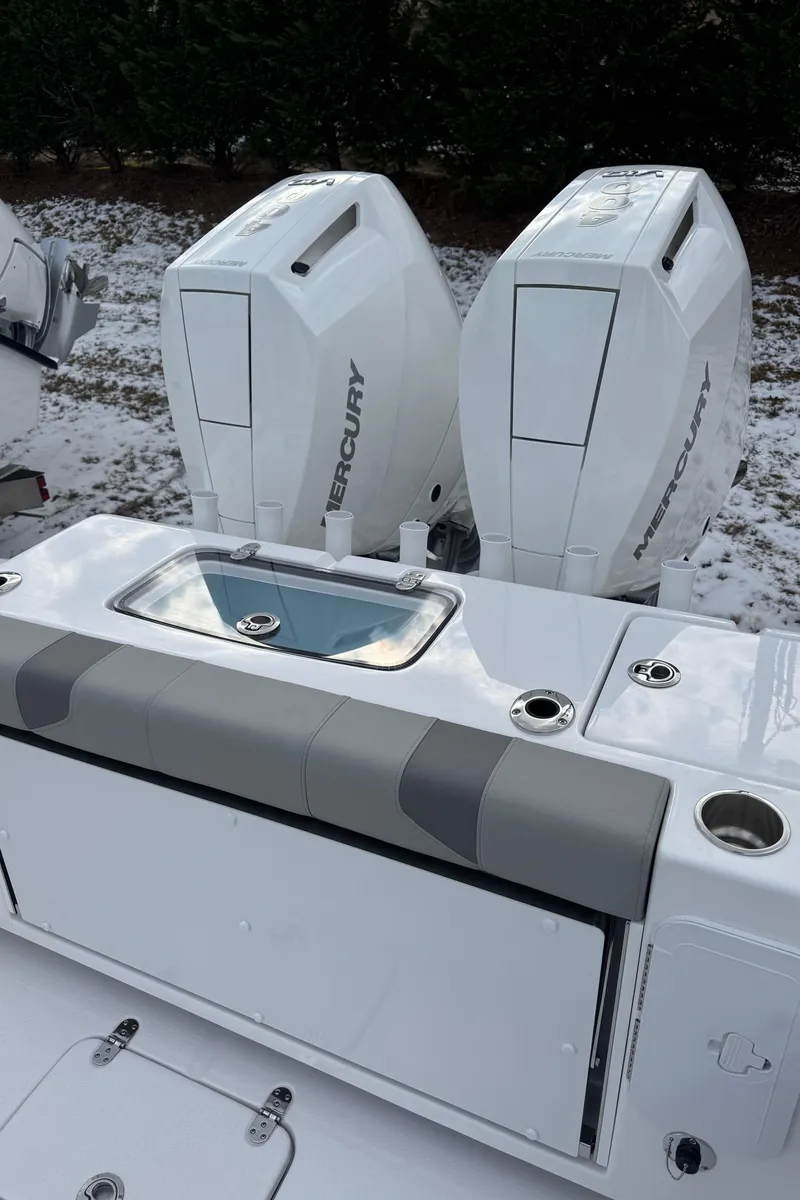 Slide: The Image of 2025 Cape Horn 34 XS boat with dual Mercury engines, rear seating, and snow-covered surroundings. - 6