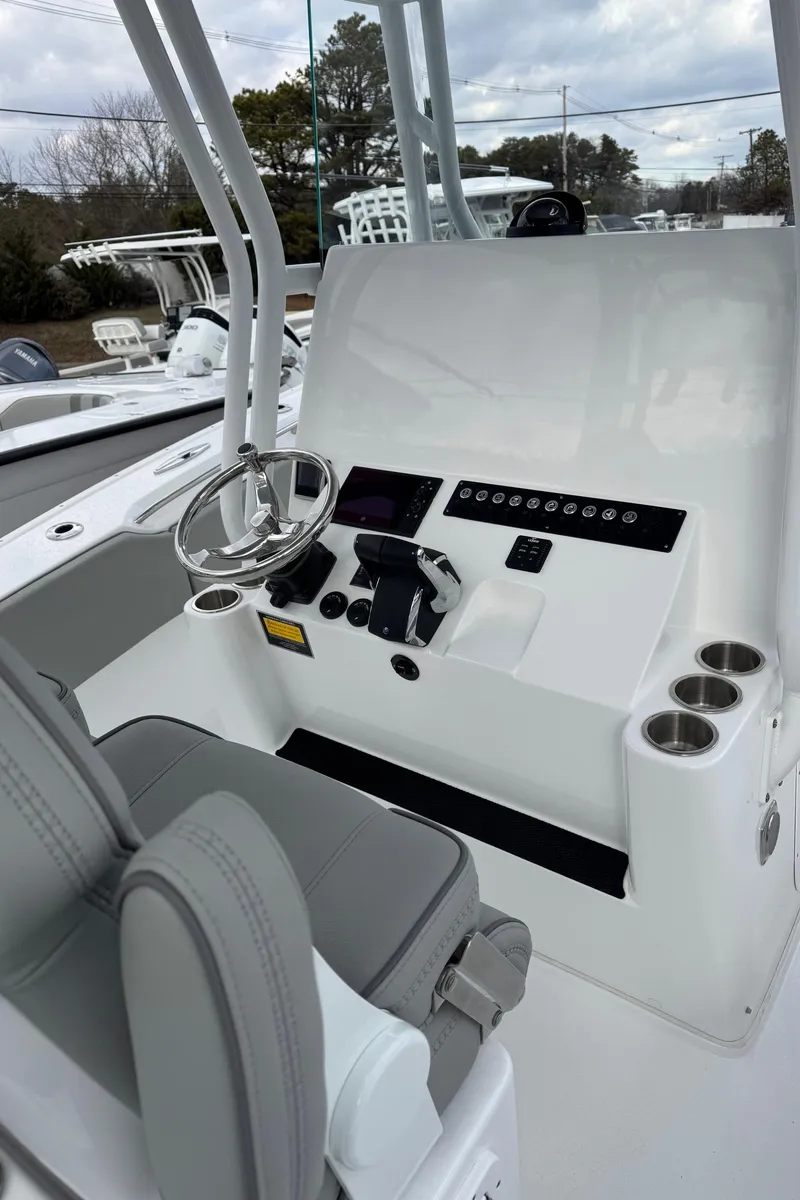 Slide: The Image of 2025 Cape Horn 34 XS boat console with steering wheel and controls, featuring modern design. - 8