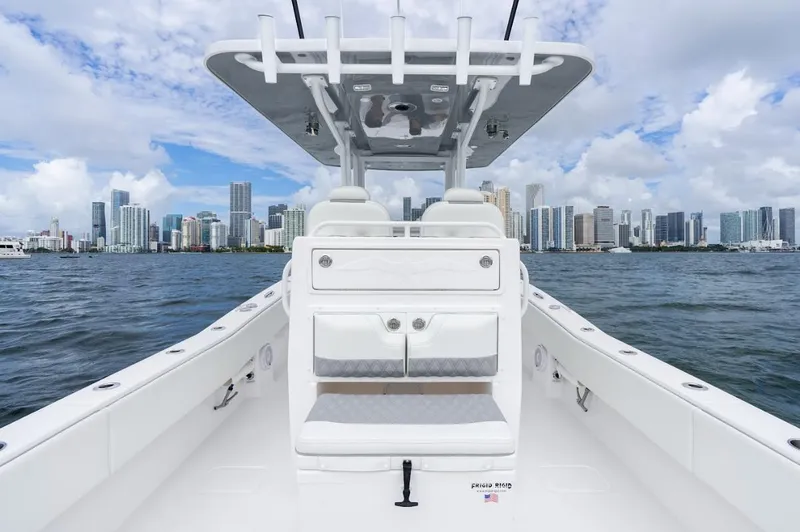Slide: The Image of 2026 Invincible 33 Open Fisherman boat with city skyline in background. - 10