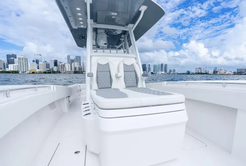 Slide: The Image of 2026 Invincible 33 Open Fisherman boat on water with city skyline background. - 11