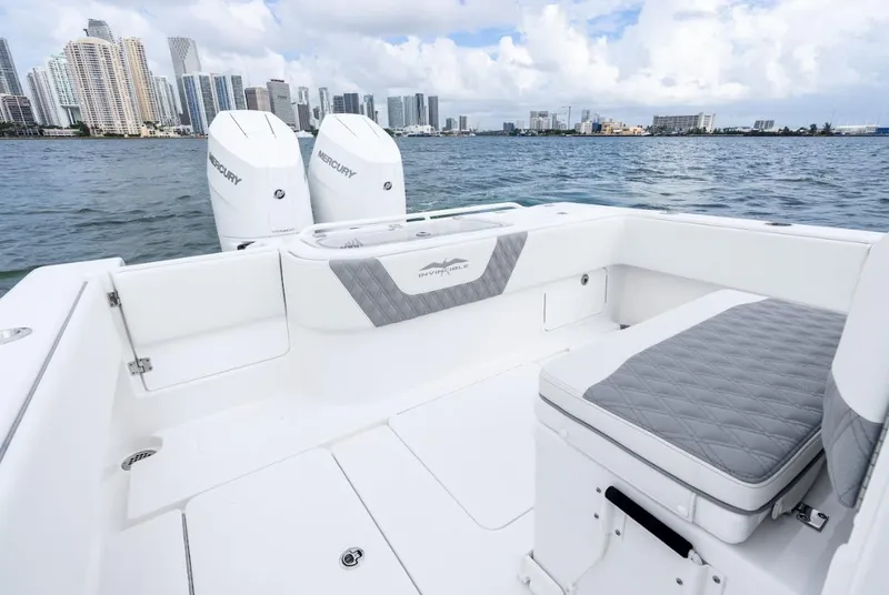 Slide: The Image of 2026 Invincible 33 Open Fisherman boat on water with city skyline in background. - 13