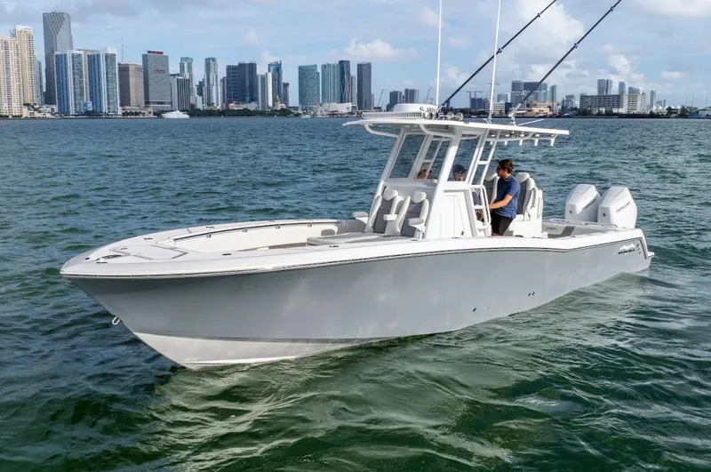 Slide: The Image of 2026 Invincible 33 Open Fisherman boat on water with city skyline in background. - 4